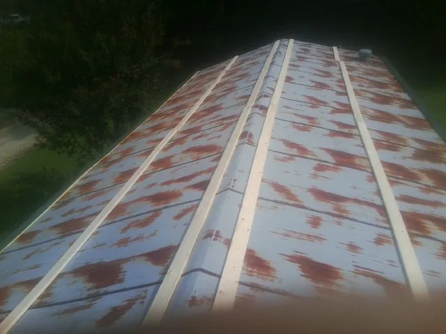 Rusted metal roof panels with new wood purlins before replacement — Storm Damage Roof Repair in Frostproof by Roofing Brothers